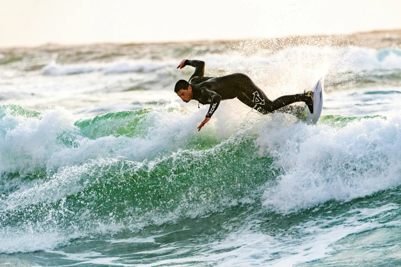 a man on a surfboard riding a wave