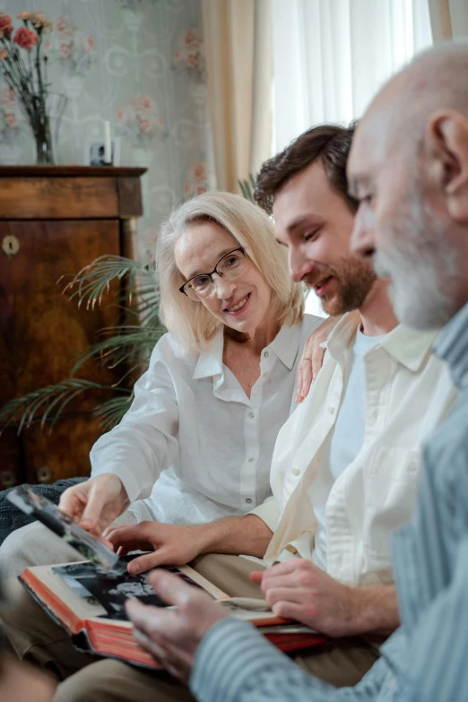 three older people are looking at pos on the wall