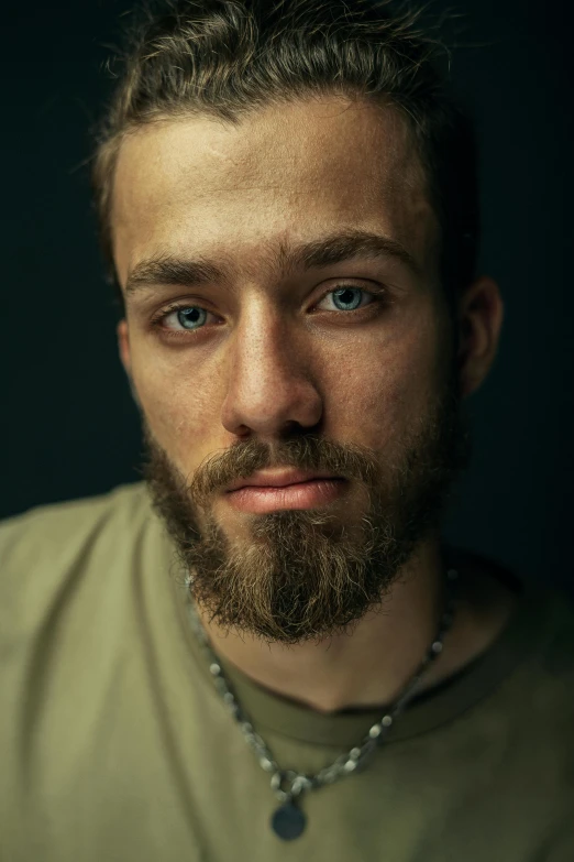 the young man is looking at the camera with blue eyes