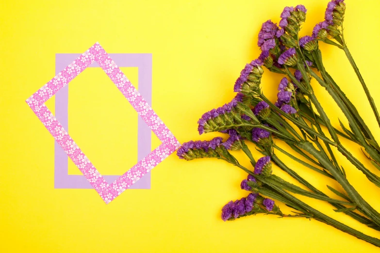 a bouquet of lavender flowers against a yellow background