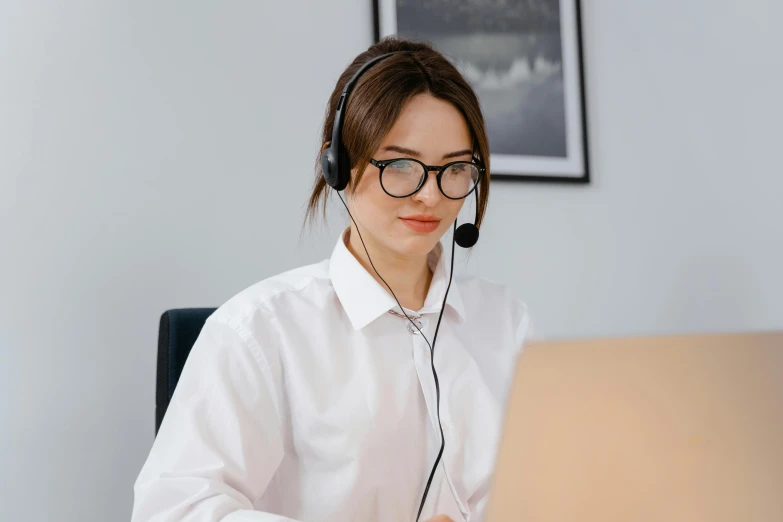 a woman with headphones on in an office