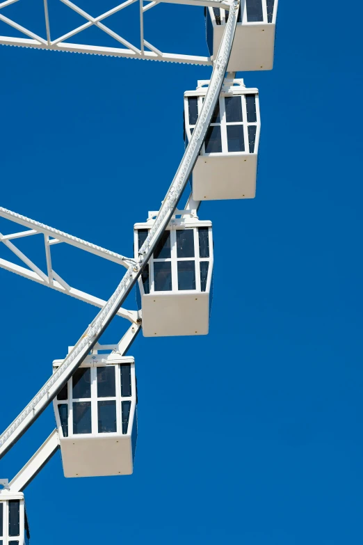 an old ferris wheel against a bright blue sky