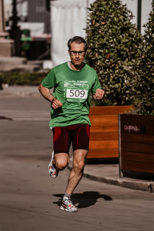 a man wearing a green shirt is running