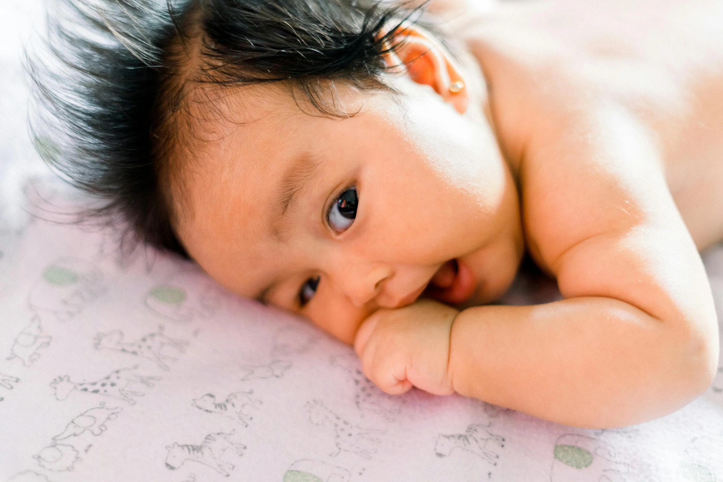 a close up po of a baby laying on the ground