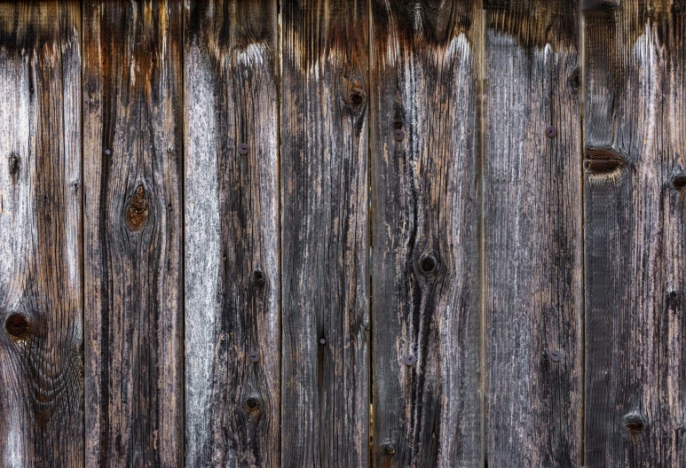 old wood planks are painted brown with white streaks