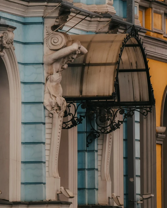 a blue and yellow building with a clock on the corner