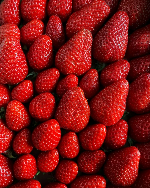 a bunch of strawberries sitting on top of each other