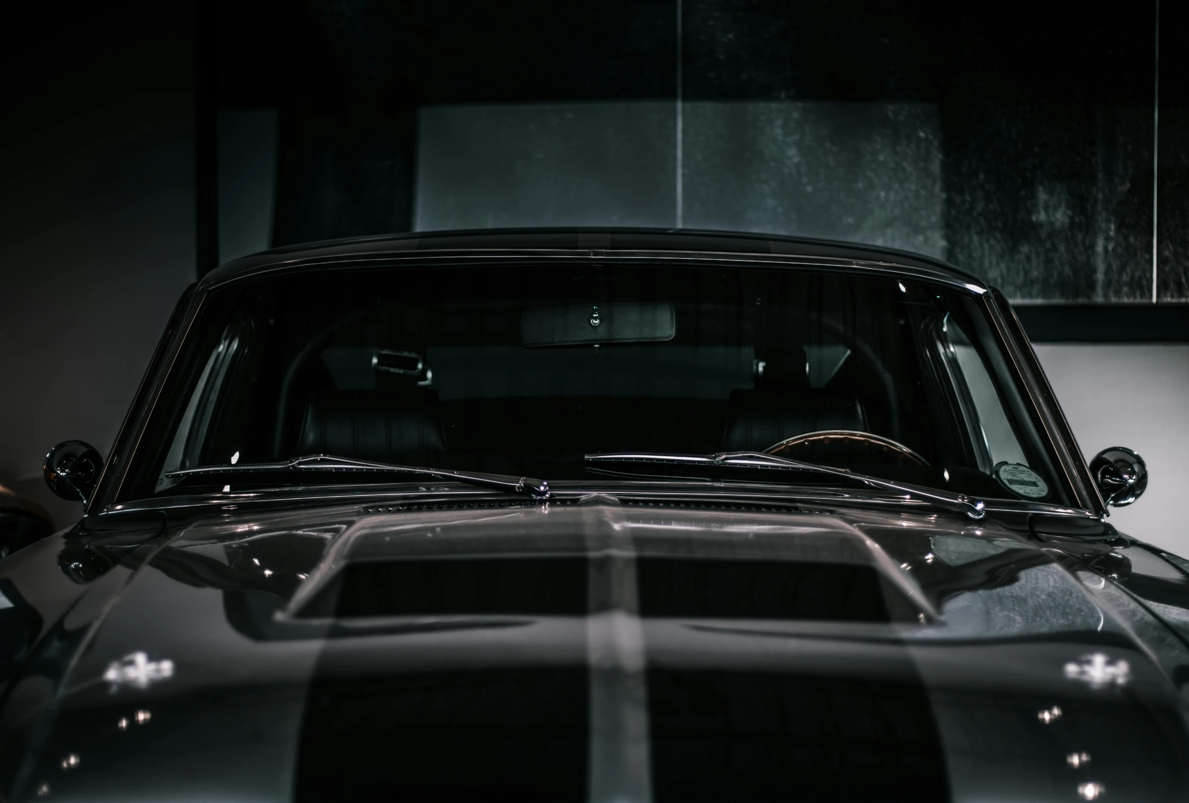 an old muscle car parked in a garage