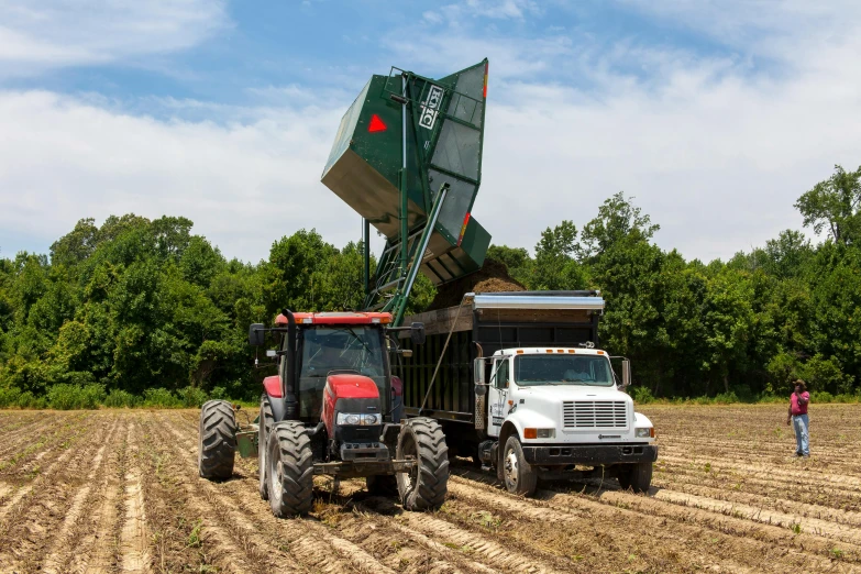 a white truck pulling a tractor behind it