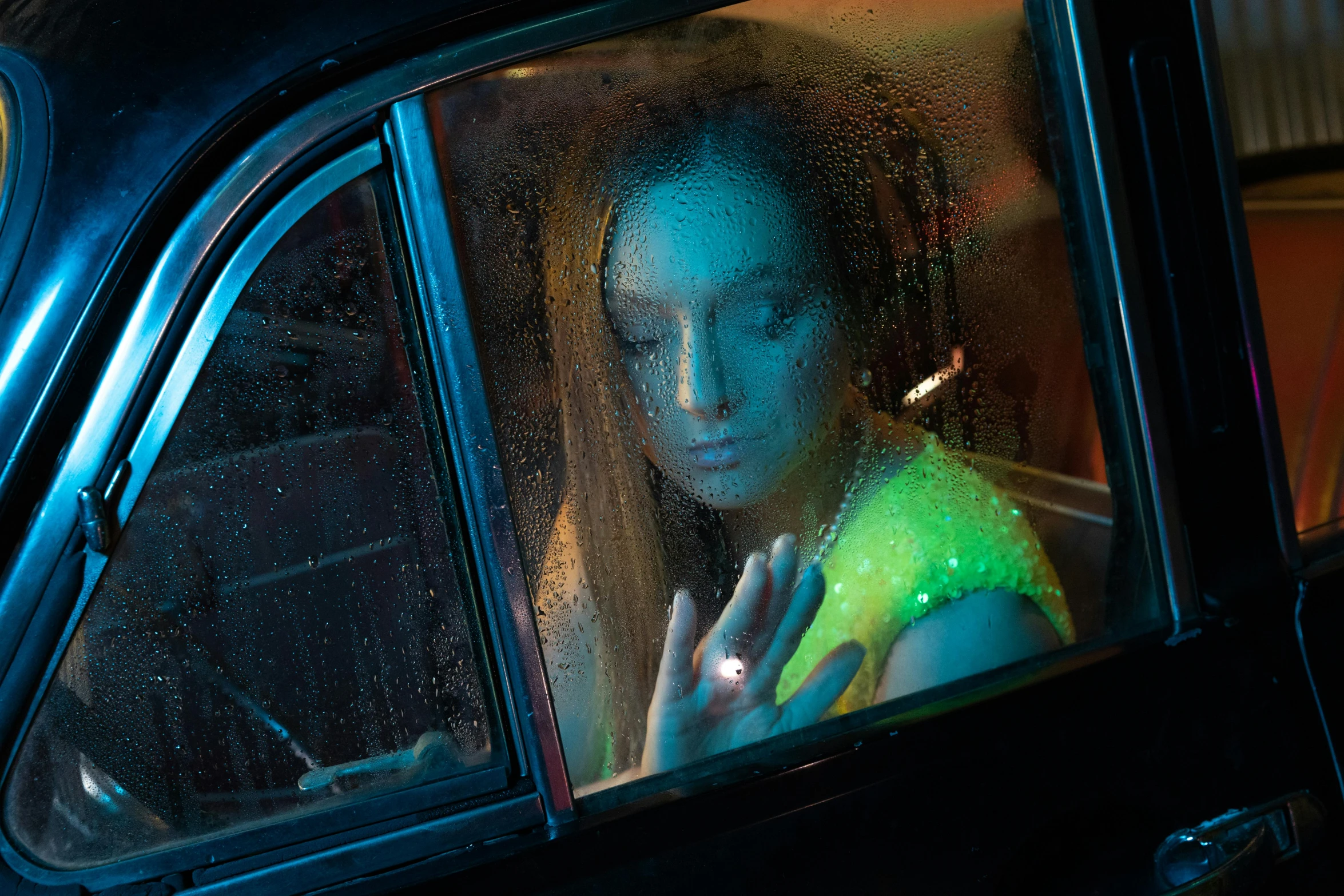 girl on the car looking outside from inside window