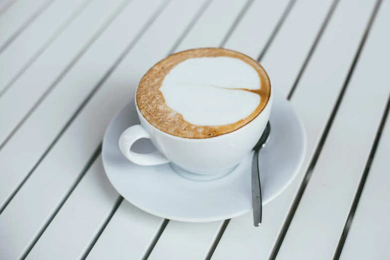 a cup of coffee with the shape of a leaf on it