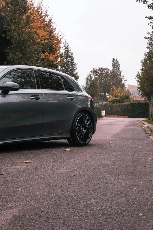 a mercedes cla sits on the street