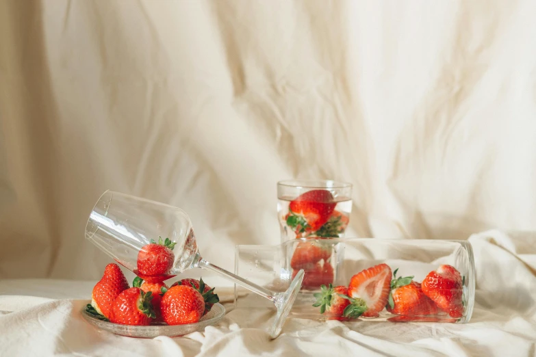 strawberries and oranges are in small jars under covers