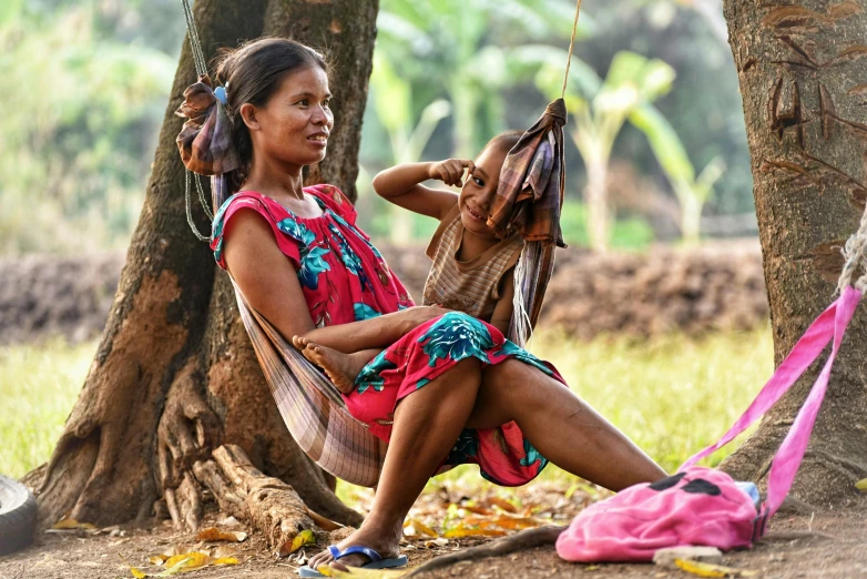 a woman sitting on a chair in the woods