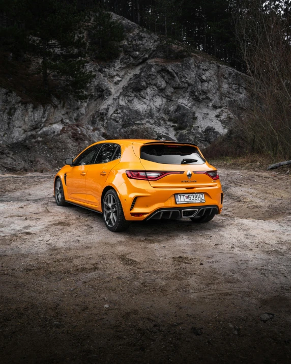 a yellow car parked in a rocky area