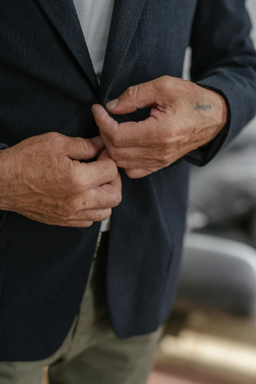 an older man wearing a suit with a pocket undone