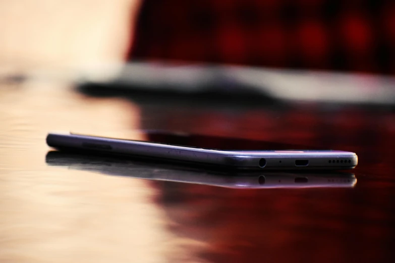 a closeup of a cell phone resting on the table