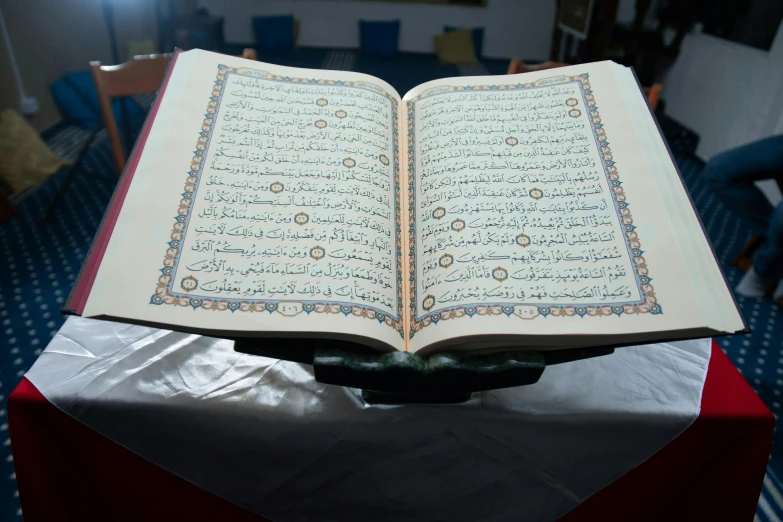 a very big beautiful old islamic book on display