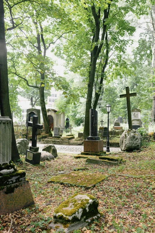 a cemetery with graves and trees in the background