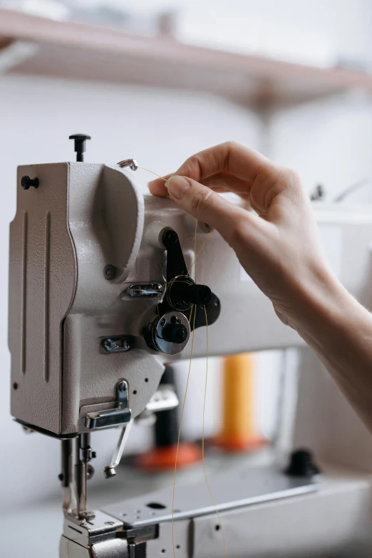 someone sews together soing on an old sewing machine