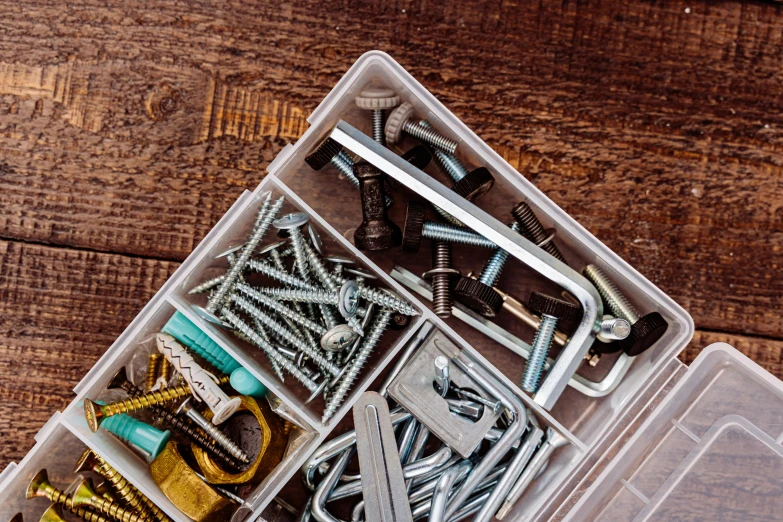 a white box full of different screws and nails