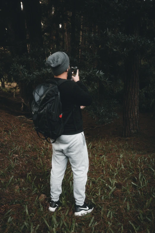 a young man standing on a field taking a picture of himself