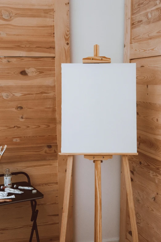 an easel with an easel stands next to a wooden wall