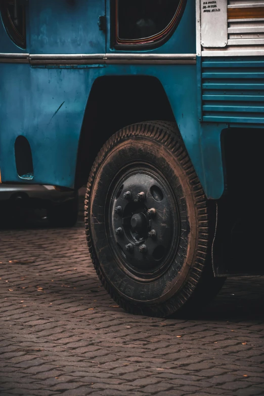 an old vehicle is parked on a brick surface