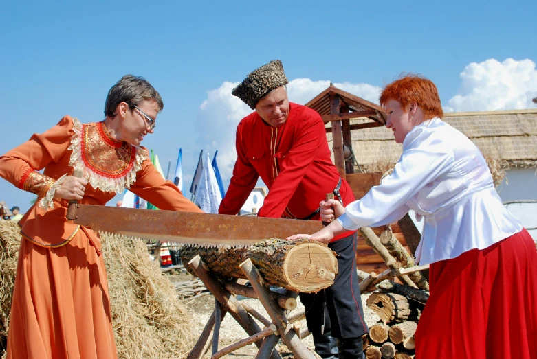 two women and a man both show off an item