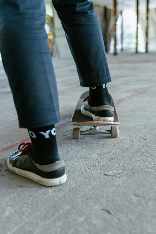 man in jeans and tennis shoes on top of a skateboard