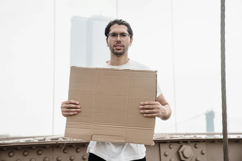 a man is holding a large cardboard box