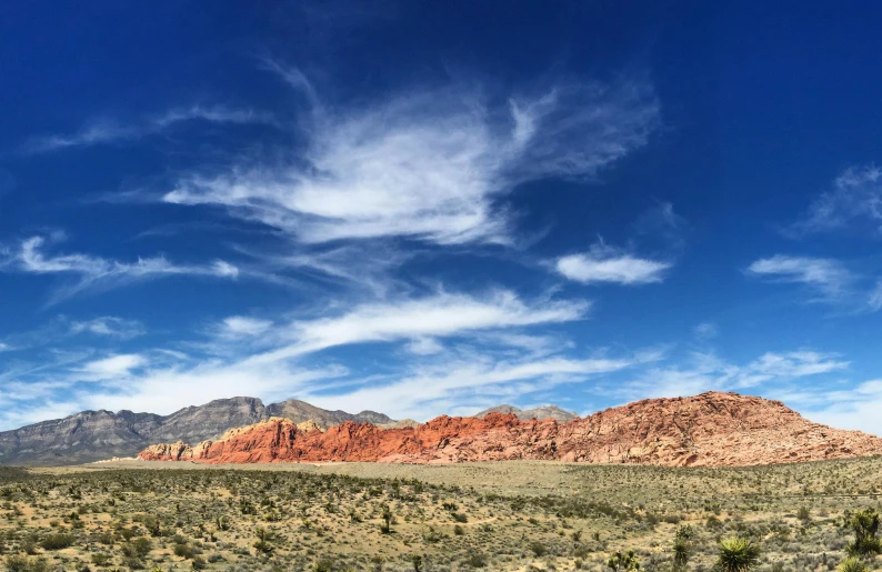 mountains in the distance on a beautiful day with white clouds