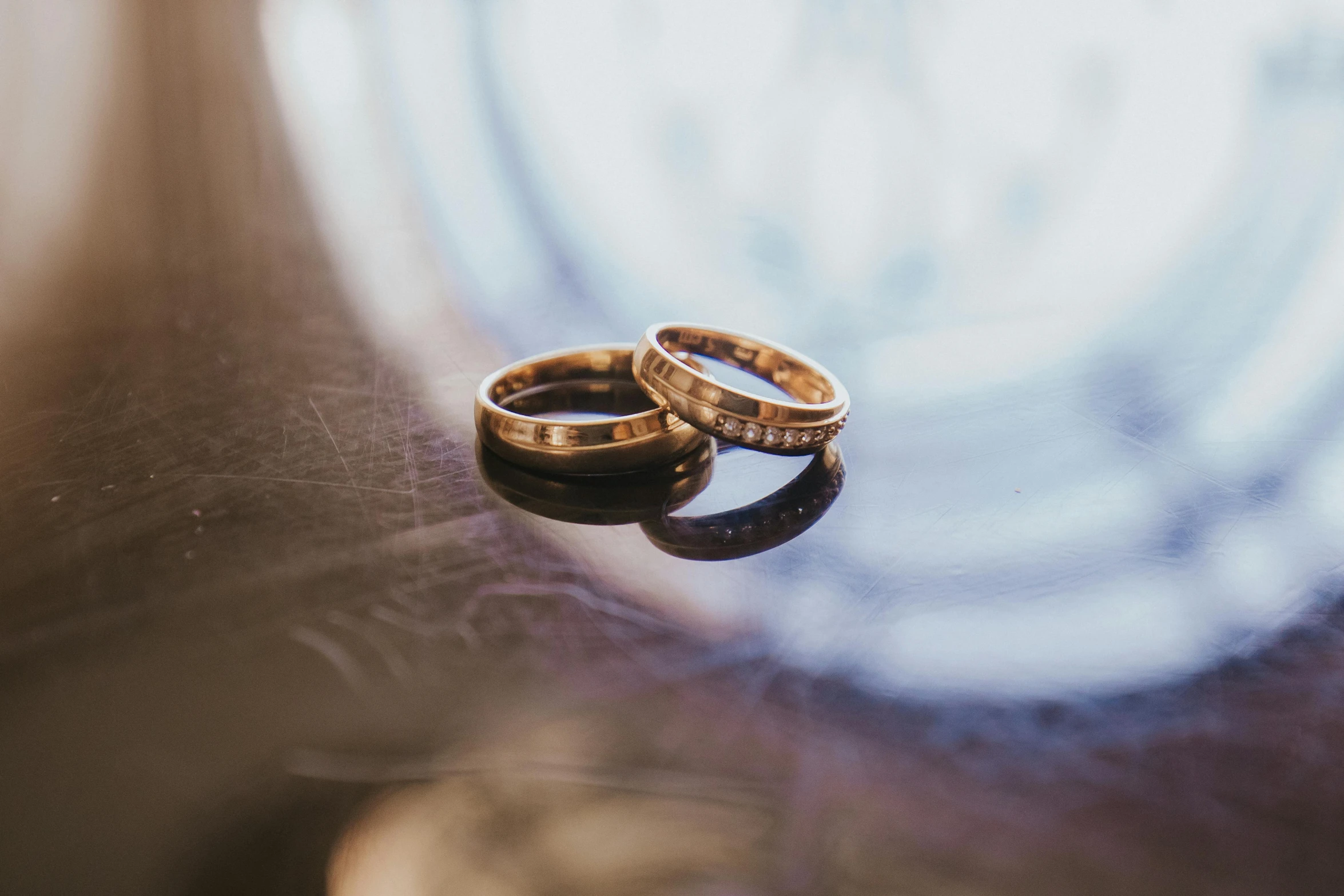 two gold rings that are sitting on a table