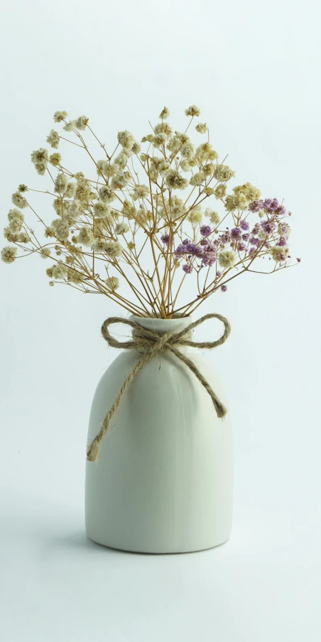 a vase that has purple and yellow flowers in it