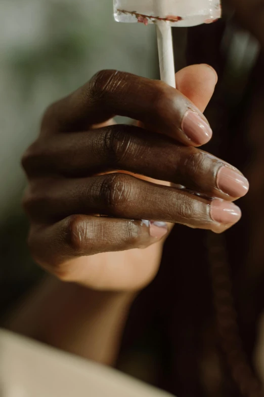 a close up of someone holding a cigarette with cigarettes in their hands