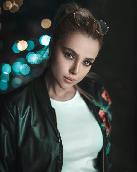 a young woman in a white top and a black leather jacket