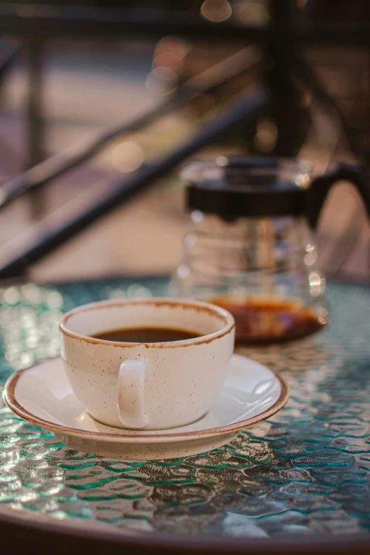 a white cup and saucer are on a saucer