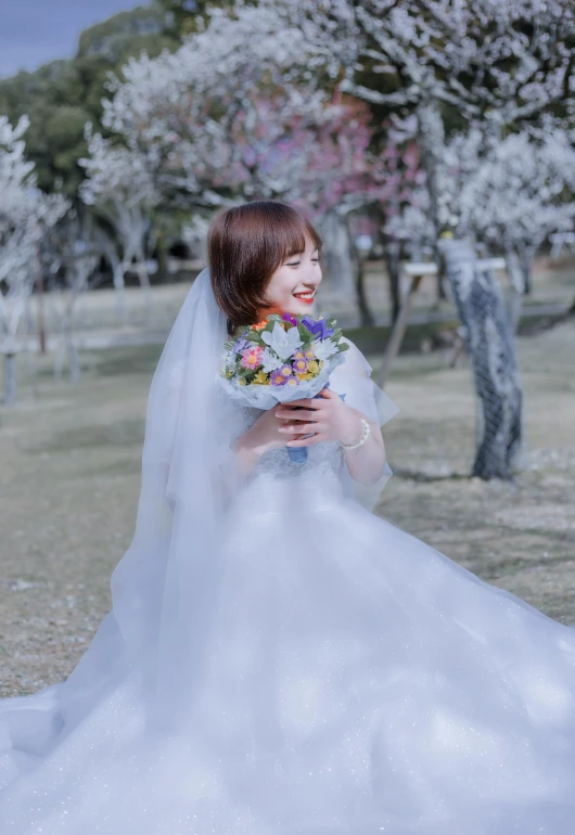 a woman dressed in a ball gown holds a bouquet