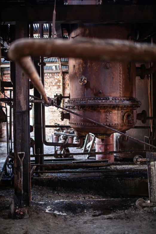 an old abandoned brick boiler with pipes and pipes