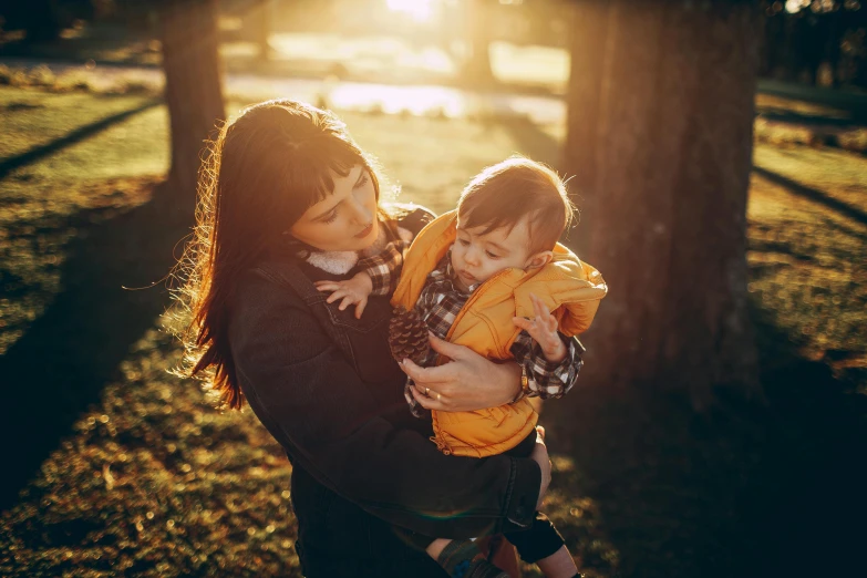 mother and child playing outside in autumn