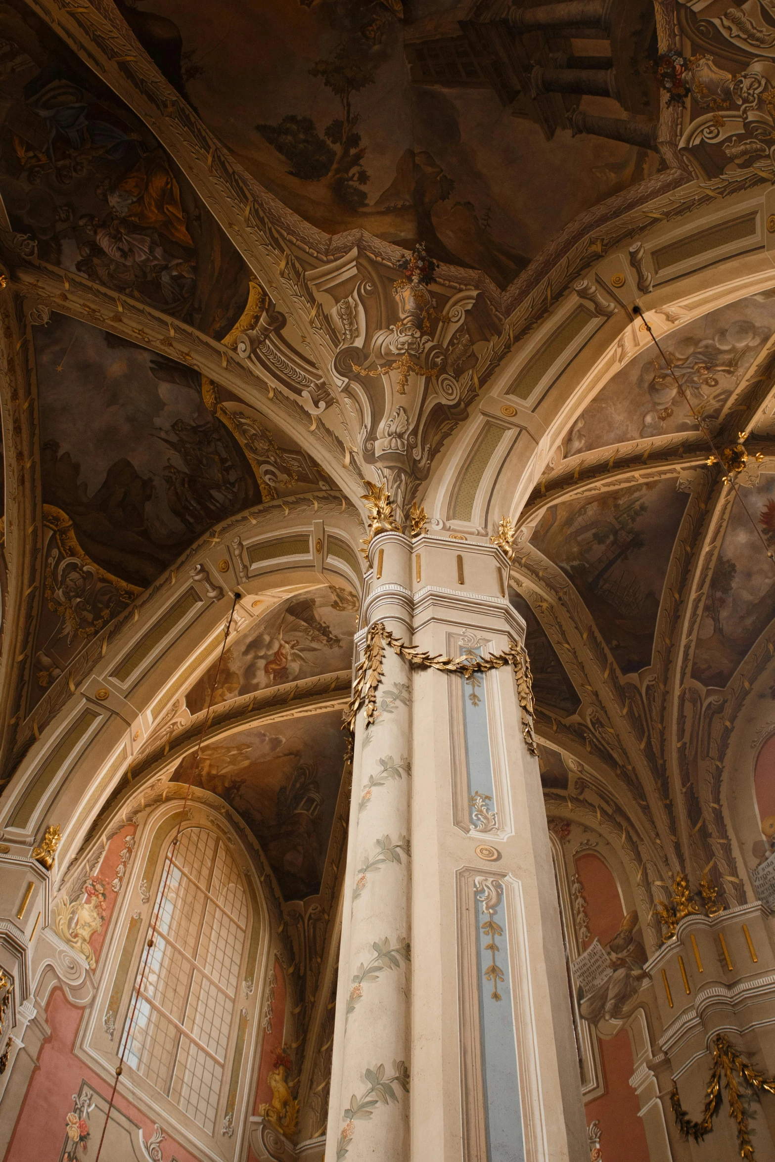 large ornate decorated columns with paintings and chandeliers