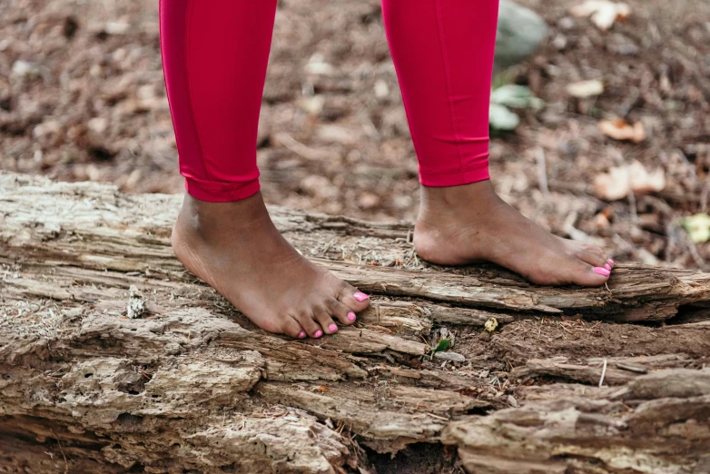 close up of a person standing on a tree trunk