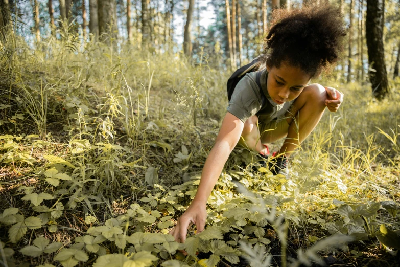 a girl is kneeling and reaching for soing