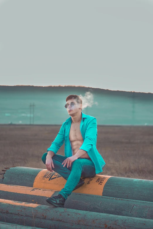 a shirtless man is sitting on top of the side of a road