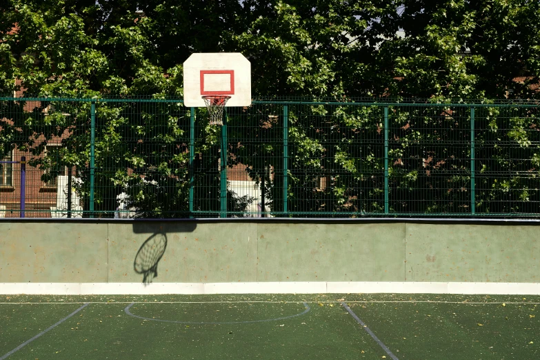 a young man dunks the basketball from his basket