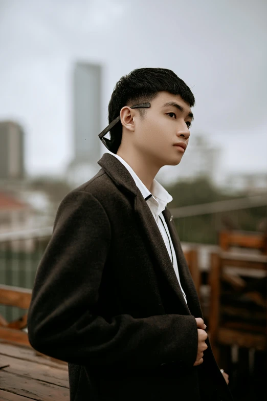 a young man standing on top of a bridge