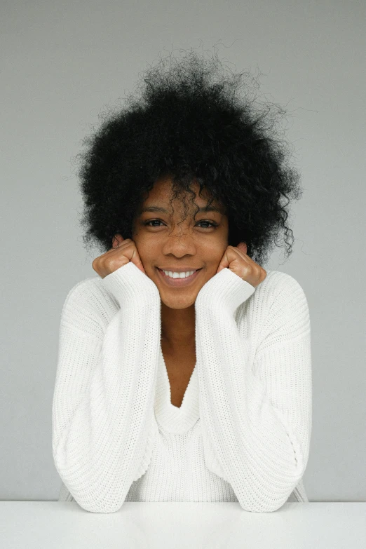 a woman with a white sweater and a smiling face