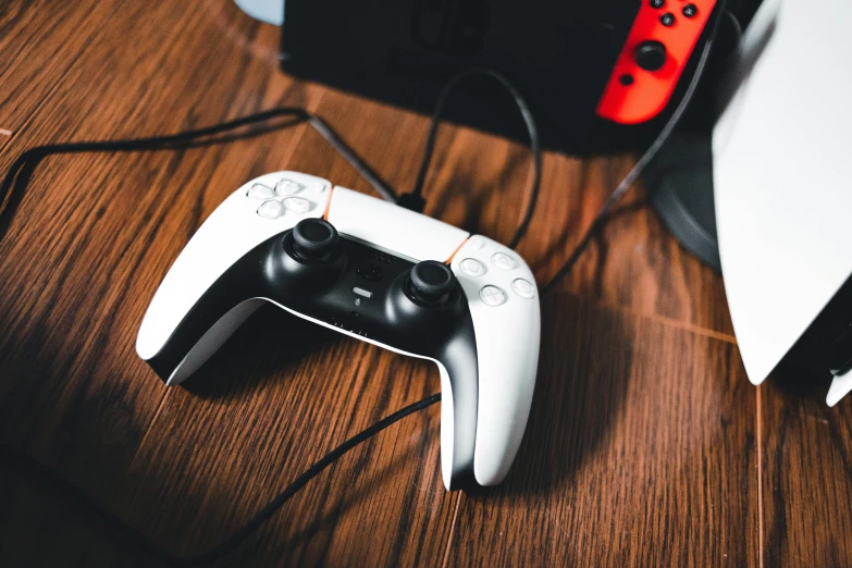 two video game controllers are sitting on a desk