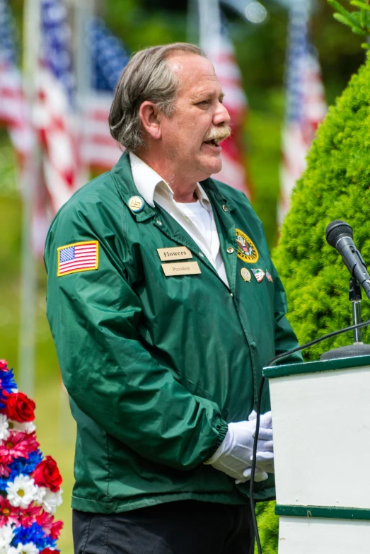 a man standing at a podium with his mouth open