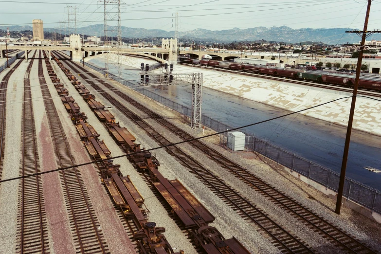 trains sit on the tracks near an overpass